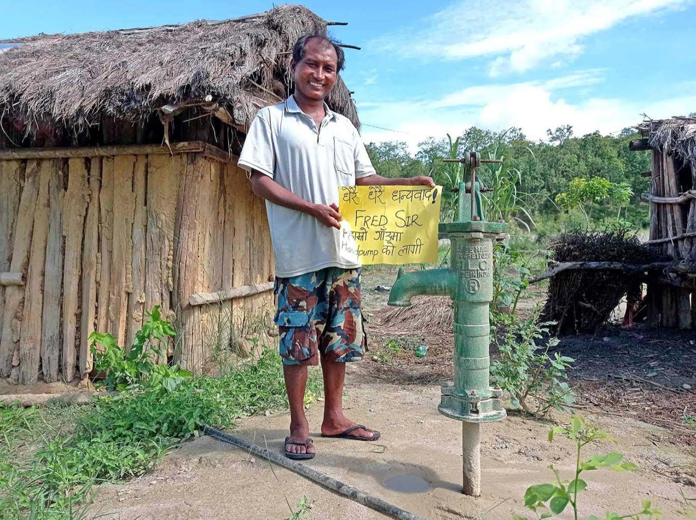 Devendapur village Head outside his house with one of the new water pumps supplied by One Golden angel